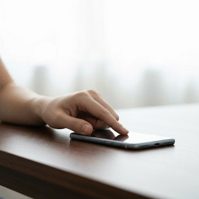 Clean, minimalist image of a person turning off a smartphone, symbolizing digital detox and setting boundaries