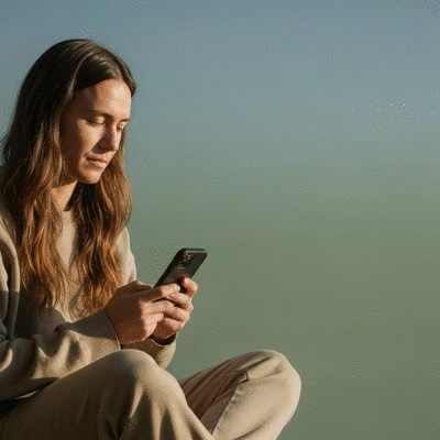Person using a meditation app on a smartphone in a peaceful setting, no text, no words, no typography, clean image
