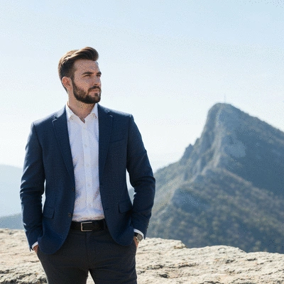 Person looking thoughtfully at a distant mountain peak, symbolizing goals and potential